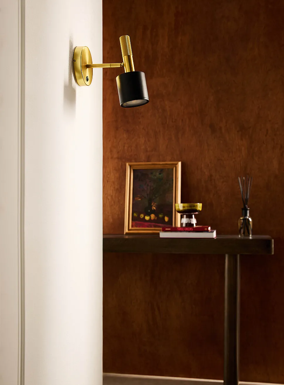 Rhoswen matte black and brass minimalist wall sconce