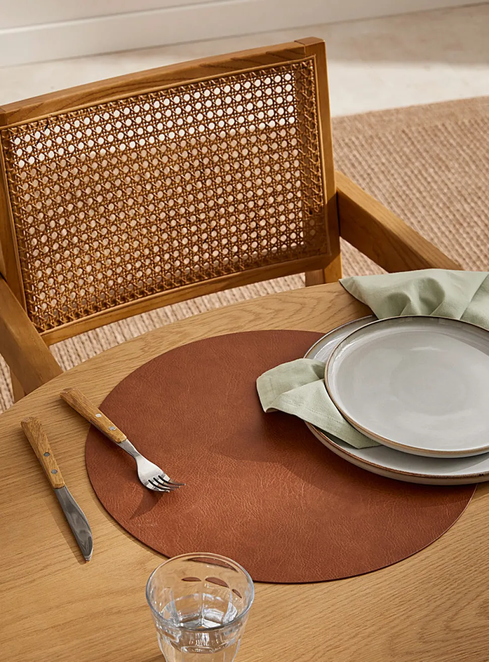 Round faux-leather placemat