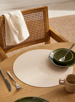 Round faux-leather placemat