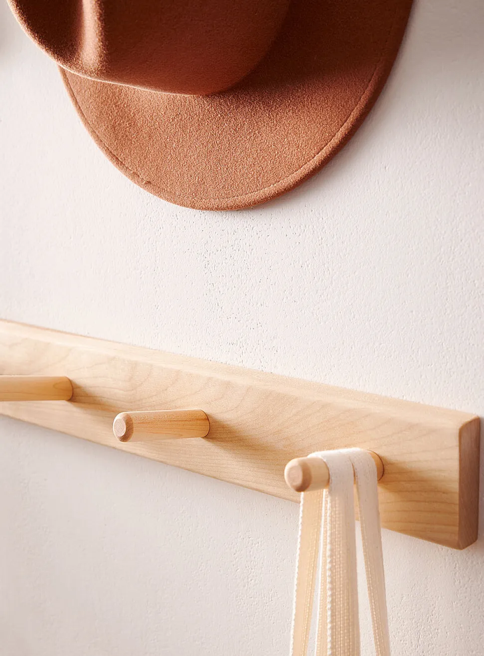 Wall-mounted dowel coat rack
